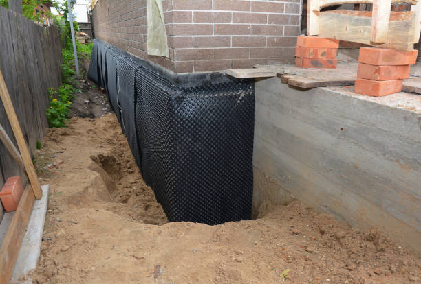SJ Waterproofing Pros technician performing targeted Sump Pump Installation assessment in Millersburg, IN